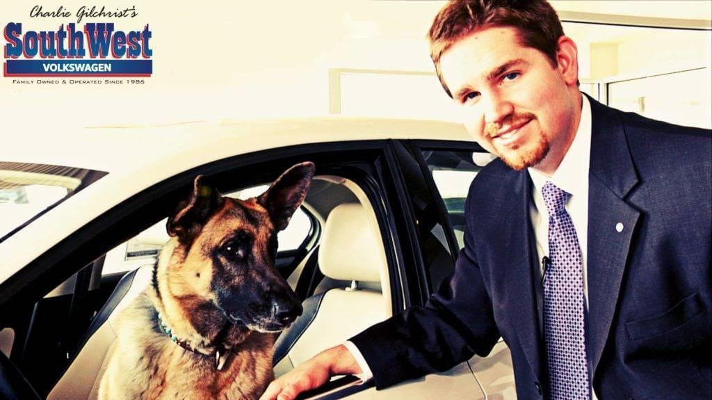 salesman with dog in car